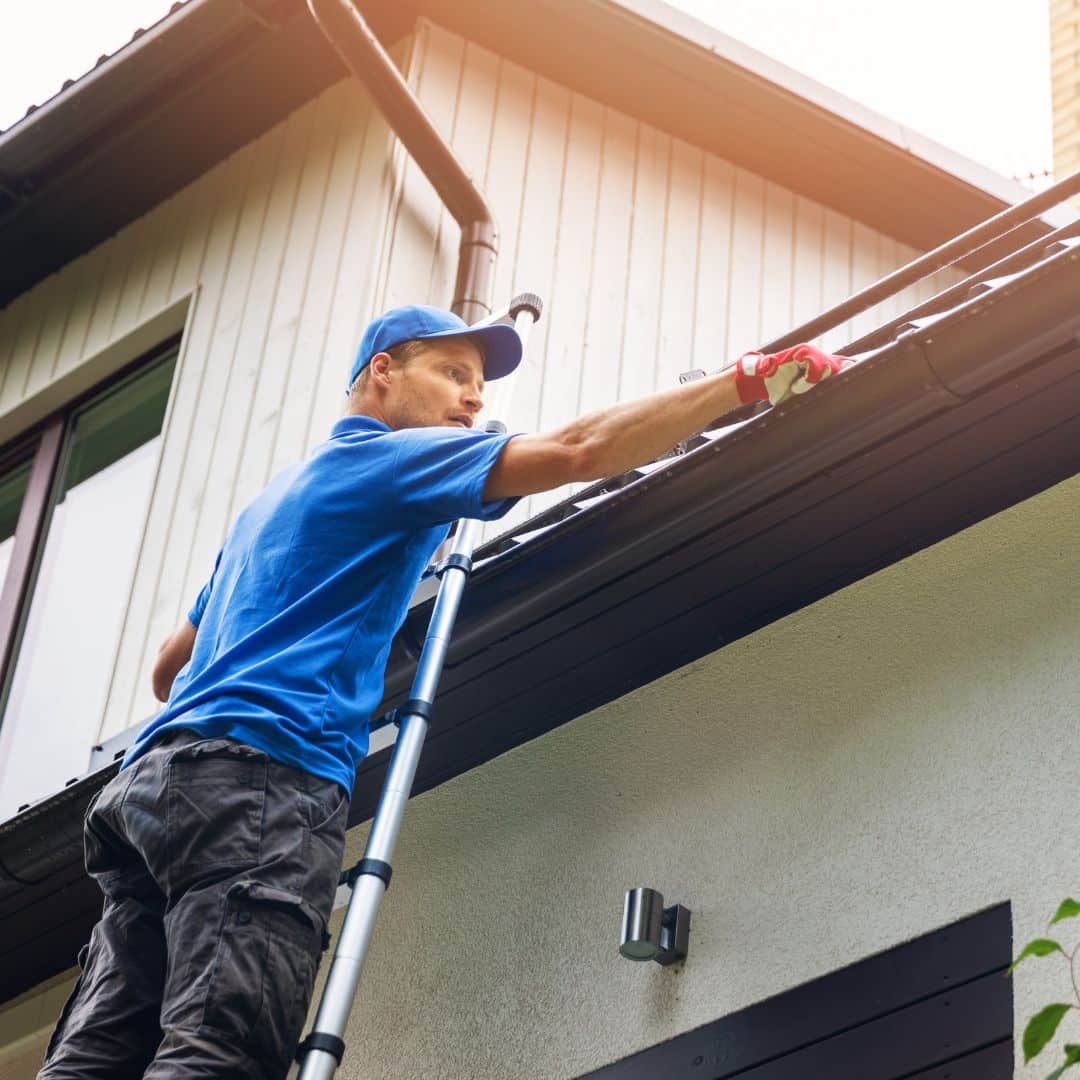 man doing gutter cleaning image